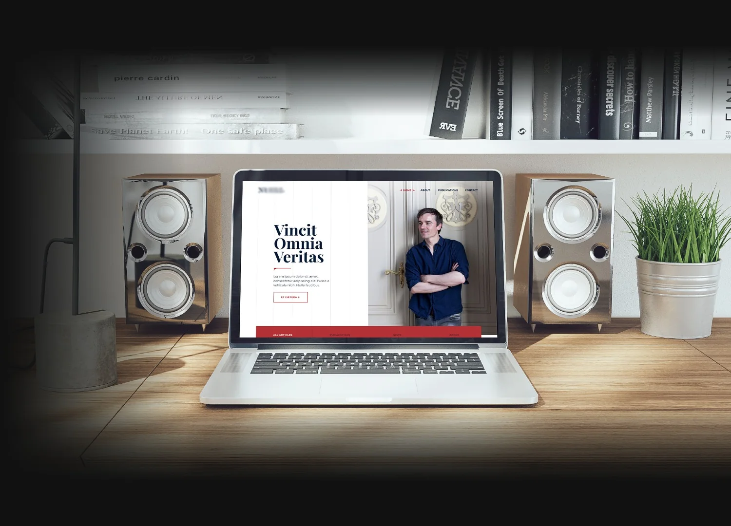 The lawyer’s homepage on a laptop, on a desk with bookshelves and speakers